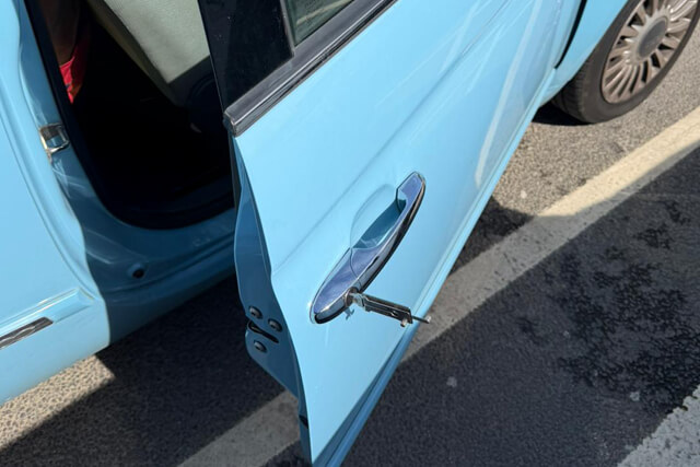 Blackpool auto locksmith gaining entry to a light blue car