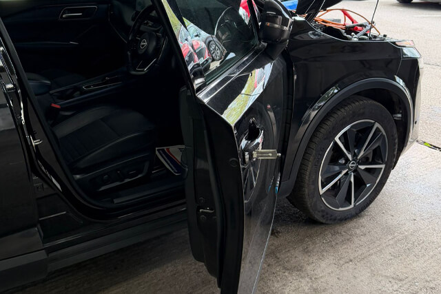Blackpool car locksmith gaining entry to a black Nissan car