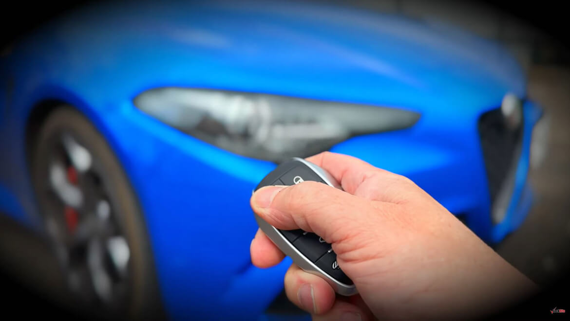 Auto Locksmith Holding Car Key Fob Pressing Button