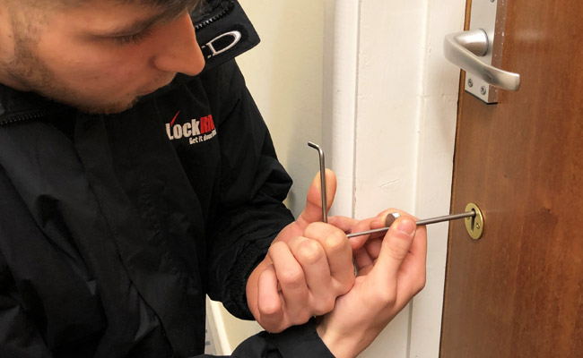 Locksmith picking door lock