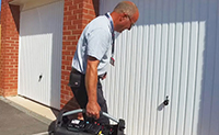 Locksmith repairing garage door lock in Newcastle